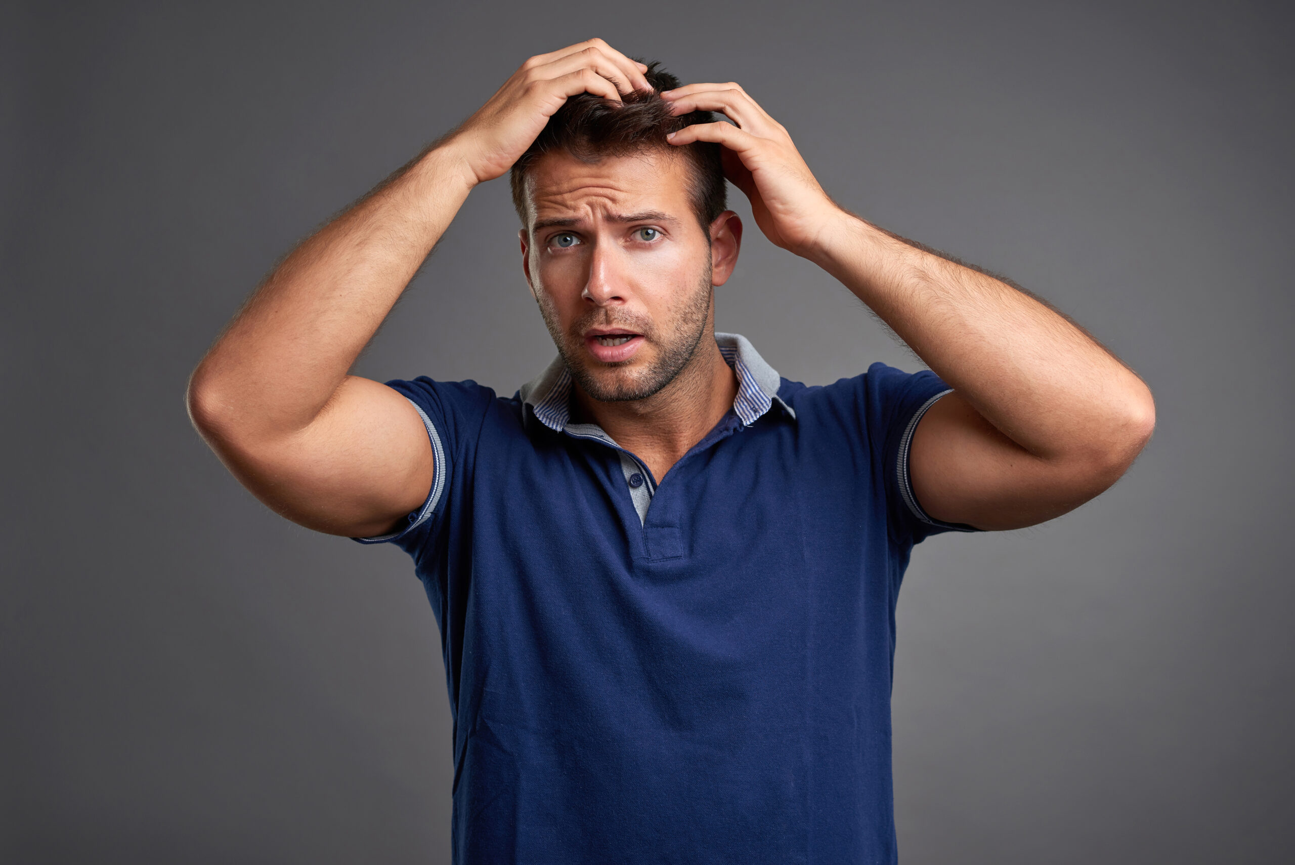 Young man worrying about hair loss